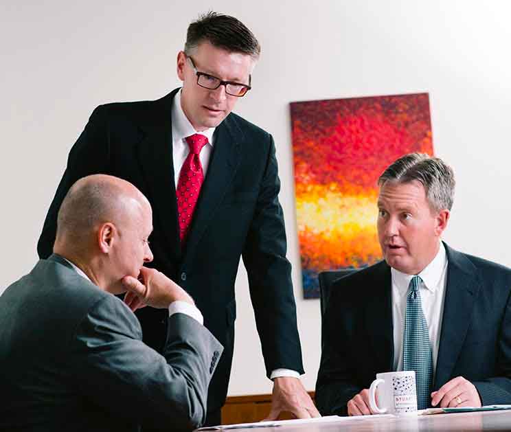 Stuart Tinley Attorneys At Table Having A Meeting